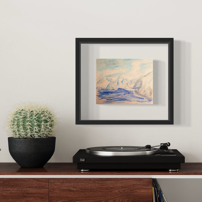 The artwork 'Dorian Bay' by Ali Ha features a serene abstract seascape rendered in soft blue and peach watercolors on warm white Stonehenge paper. Delicate ink lines suggest mountainous forms rising from tranquil waters, creating a minimalist coastal scene. Displayed in a sleek black frame, the piece conveys a peaceful, ethereal atmosphere through its gentle color palette and fluid brushwork.