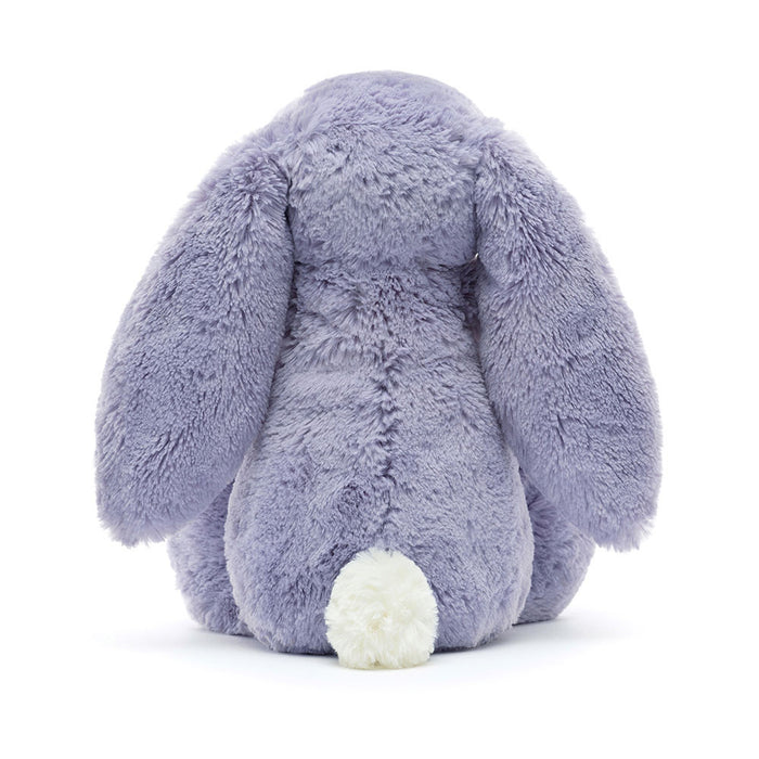 Rear view of a plush toy rabbit in purple on a white background