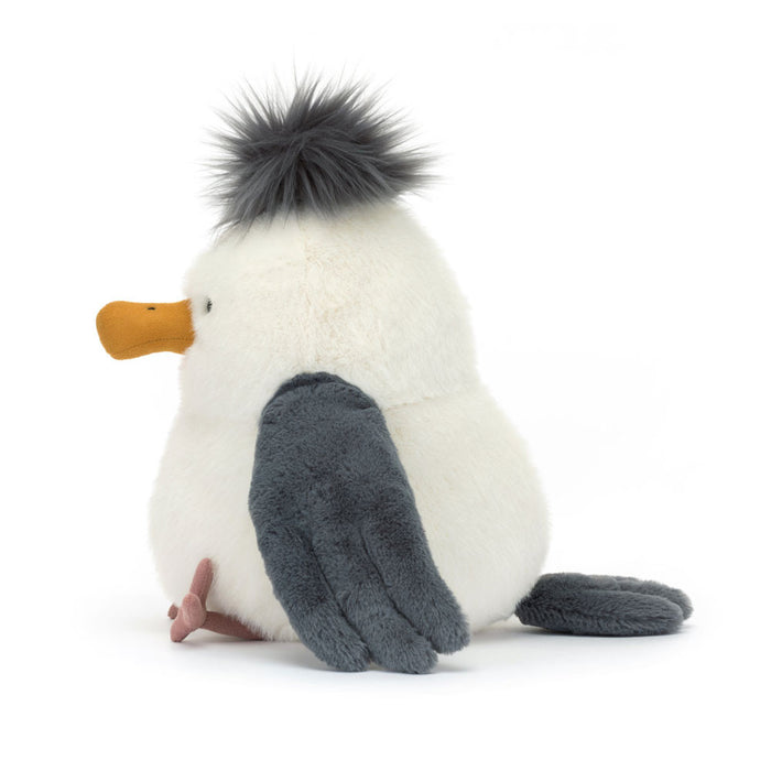 Plush seagul toy with a white body, gray wings, and black fluffy top of the head on a white background.