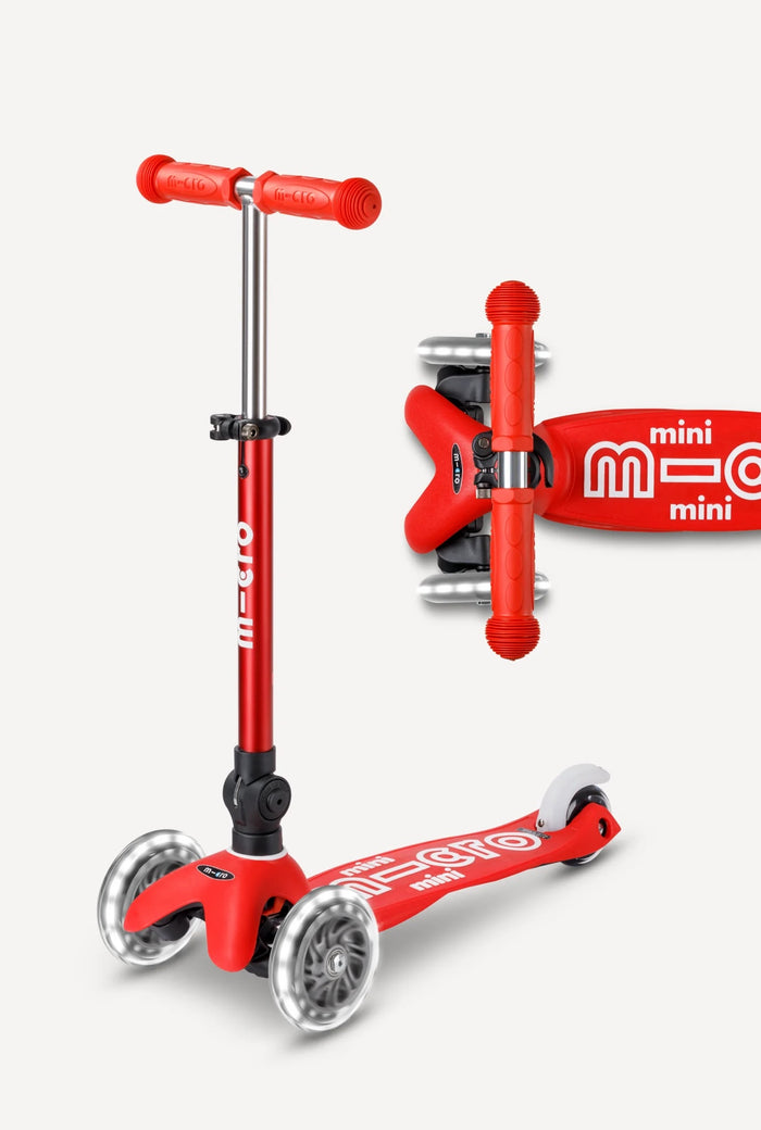 Red scooter with handlebar attachment on a white background