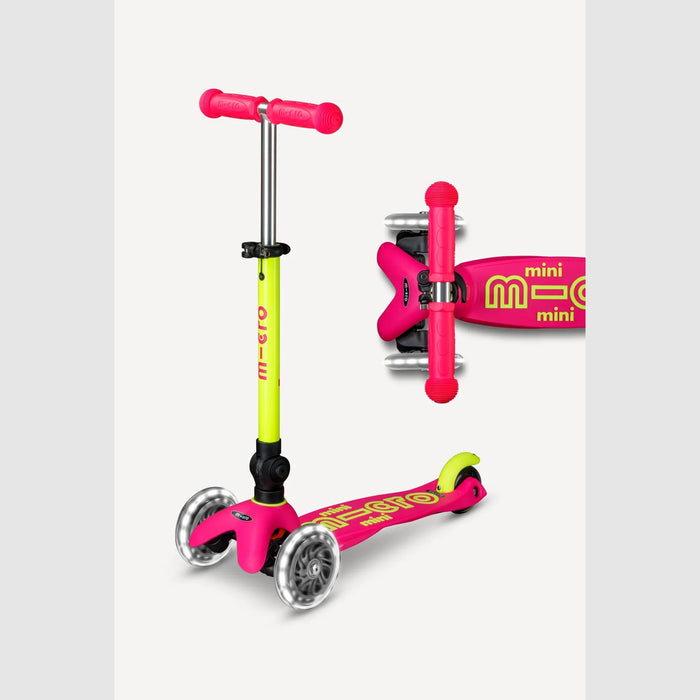 Pink and green scooter with a close-up of the brand logo on a light gray background