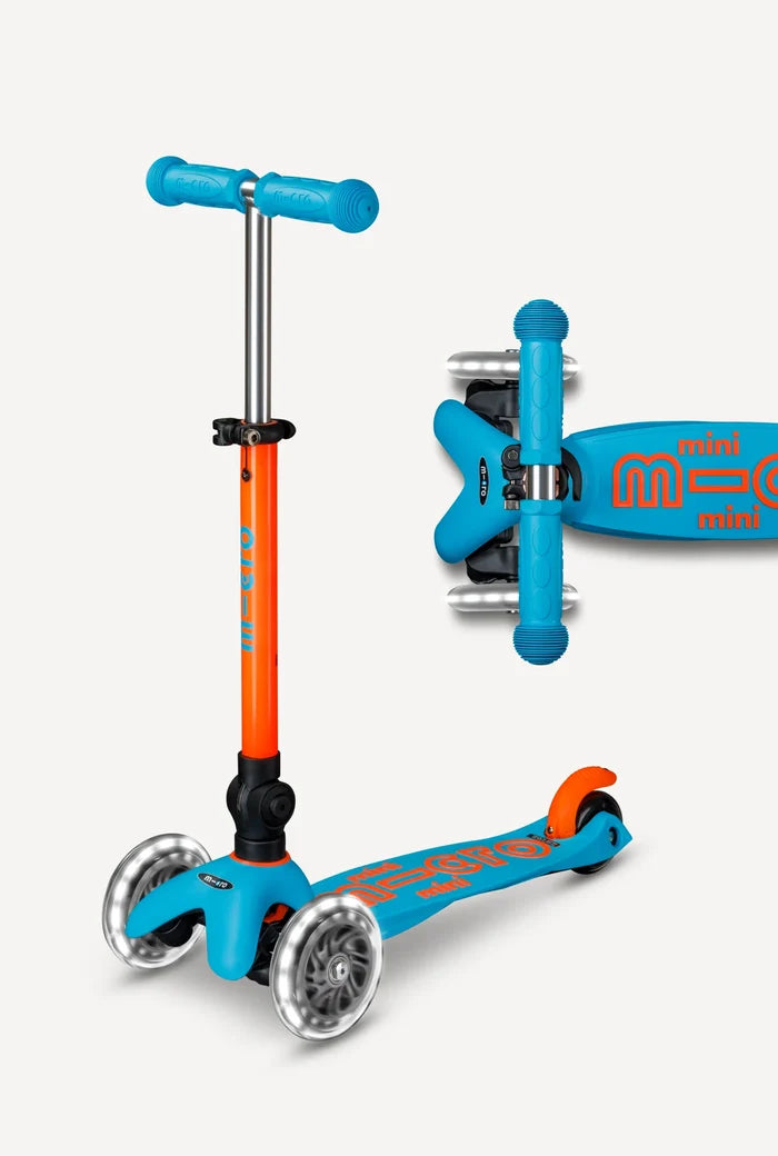 Two children's scooters, one orange and blue, the other blue with a visible brand logo, on a white background.