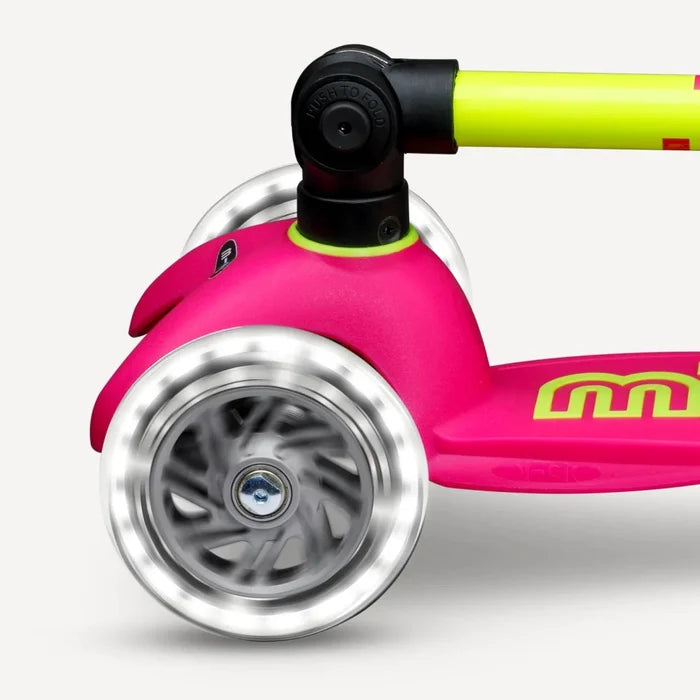 Close-up of a pink scooter with a silver wheel on a white background