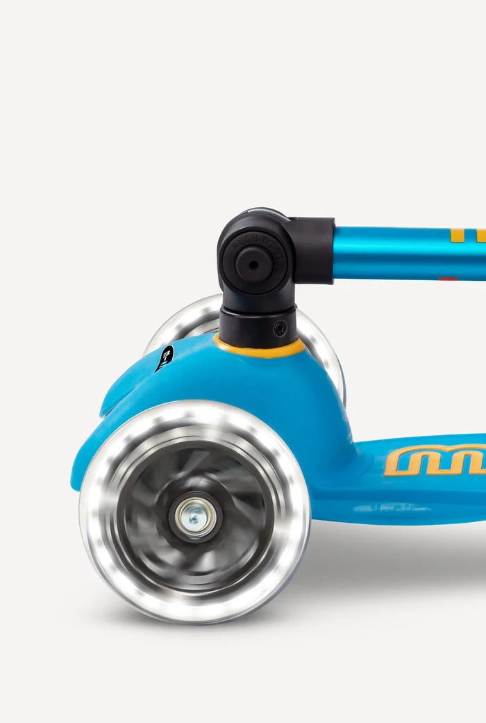 Close-up of a blue scooter with a silver wheel on a white background