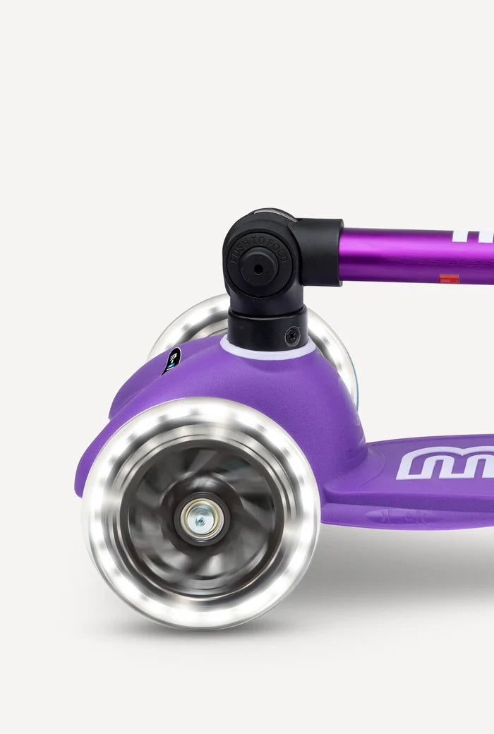 Close-up of a purple scooter with a white background