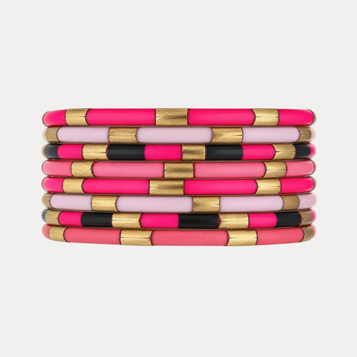 a stack of pink and black bracelets