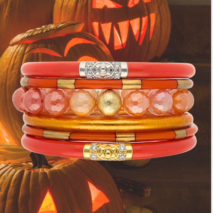 a stack of bracelets with carved pumpkins