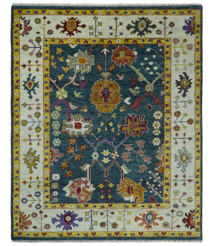Oriental area rug with teal central medallion and ivory border in warm colors
