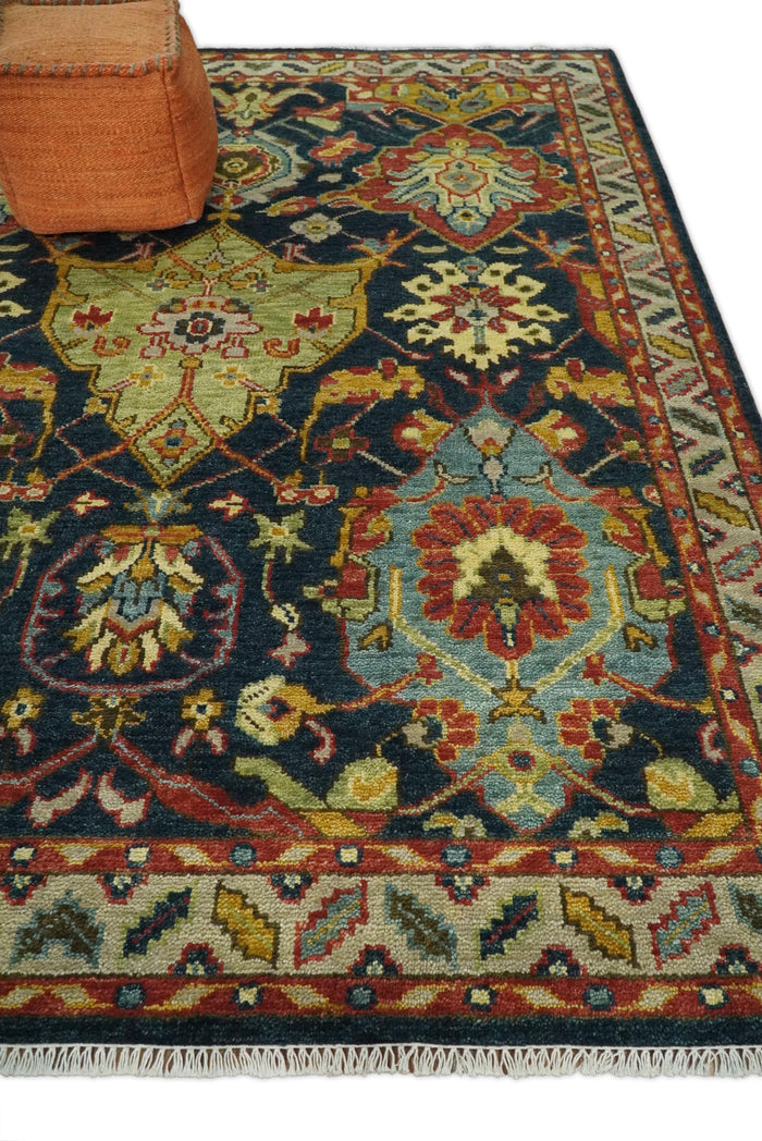 Hand-knotted wool area rug with navy, teal and rust floral medallions and fringe